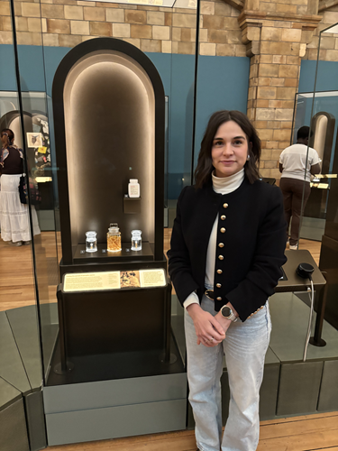 Marina Papaiakovou stands next to her display in the Fixing Our Broken Planet exhibition