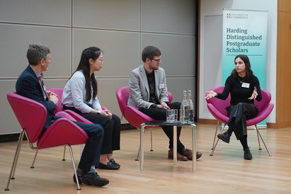 The keynote speakers discussing their research with Professor Sir John Aston