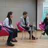 The keynote speakers discussing their research with Professor Sir John Aston