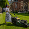 Francesca Gardner stood behind mower at St Catharine's College, Cambridge