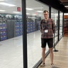Maximilian Kraus next to the AURORA supercomputer