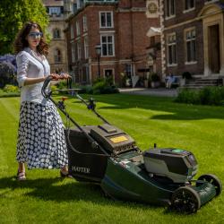 Francesca Gardner stood behind mower at St Catharine's College, Cambridge