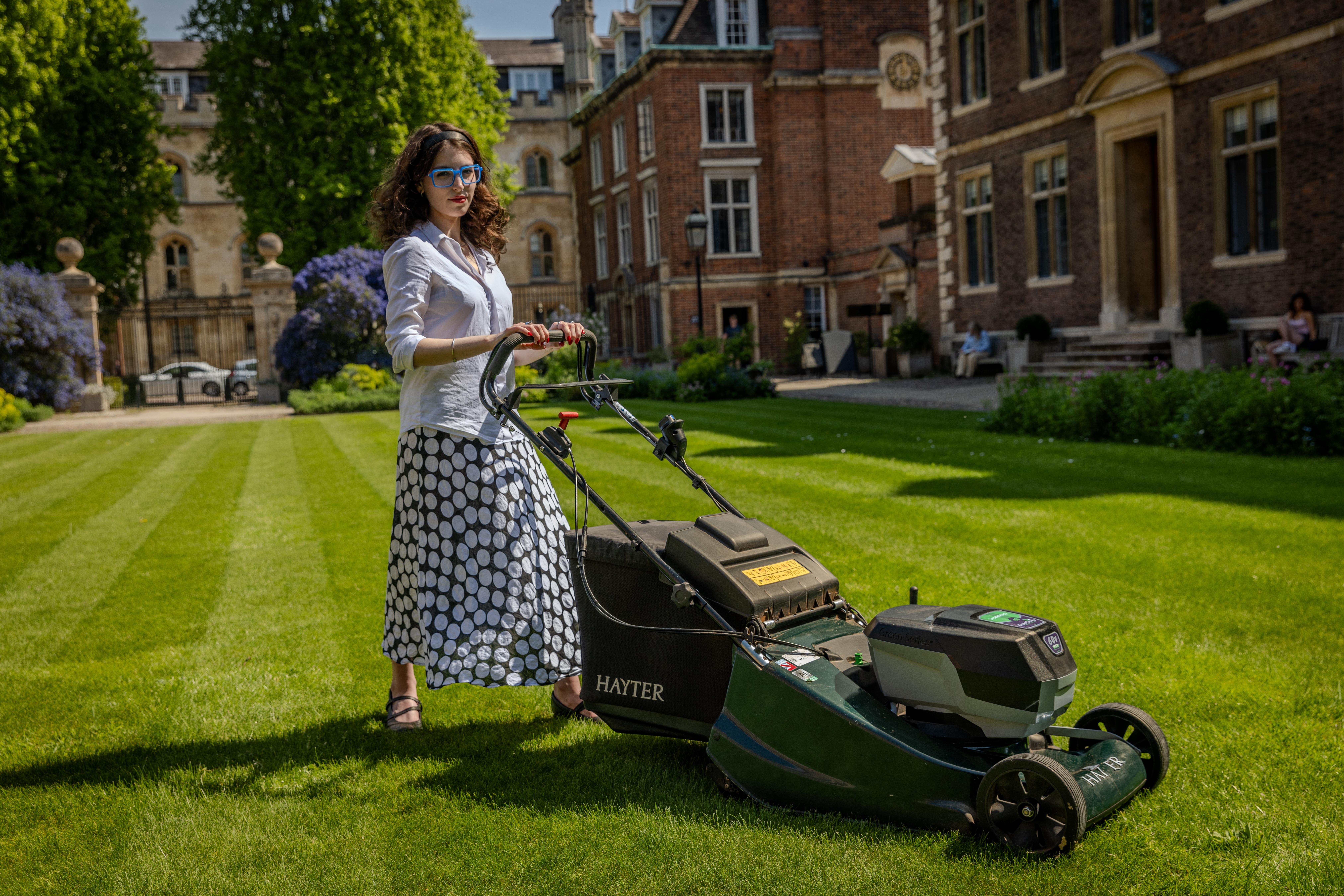 Francesca Gardner stood behind mower at St Catharine's College, Cambridge. Credit: University of Cambridge Francesca Gardner stood behind mower at St Catharine's College, Cambridge