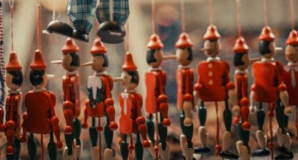 Wooden puppets hanging on strings