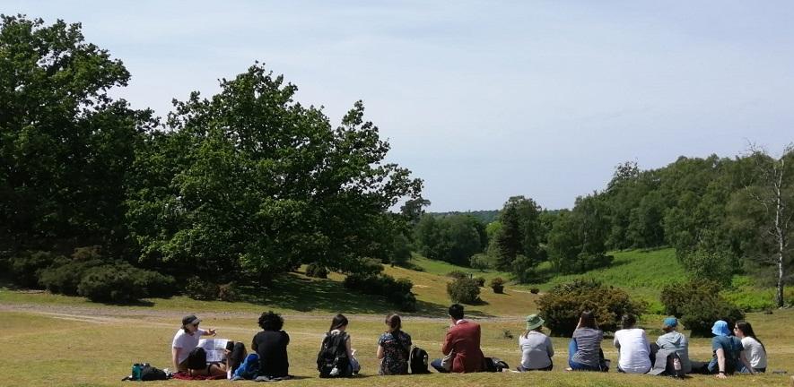 A group of Harding Scholars sitting outside at Sutton Hoo